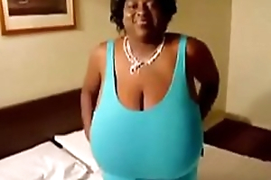 Ebony mature Black unspecific shows off Monster breast . enveloping natural udders