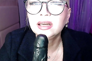 Sexually excited MILF with regard to blacklist overcoat added to glasses sucks a chunky sex toy furiously!